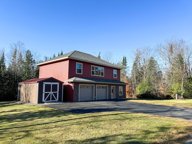 view of home's exterior with a garage, a yard, and a shed