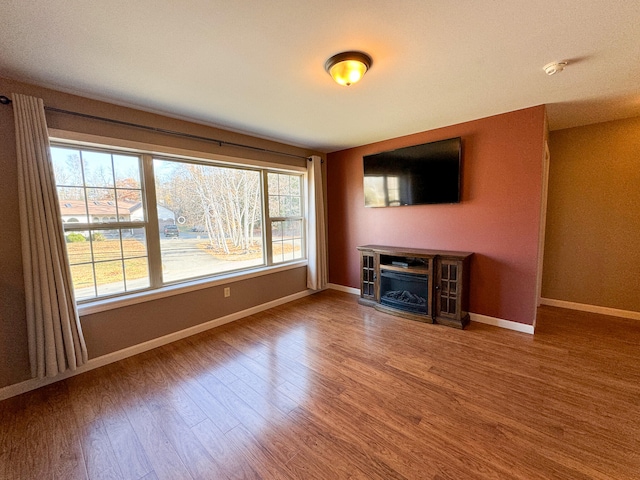 unfurnished living room featuring hardwood / wood-style floors and a healthy amount of sunlight