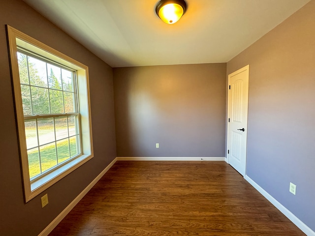 unfurnished room featuring dark hardwood / wood-style floors