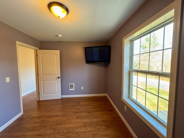 empty room with dark wood-type flooring