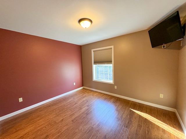 unfurnished room featuring hardwood / wood-style flooring