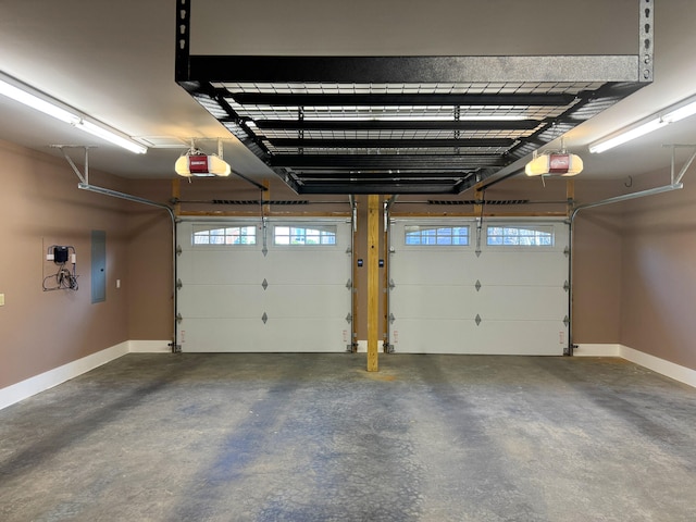 garage with electric panel and a garage door opener