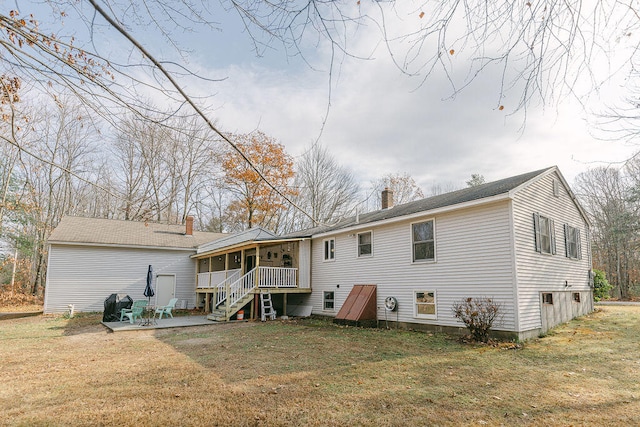 back of house with a yard and a patio area