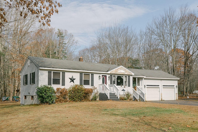 view of front facade featuring a garage, a front yard, and a porch