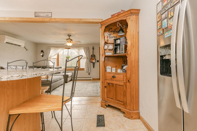 tiled dining area featuring an AC wall unit and ceiling fan