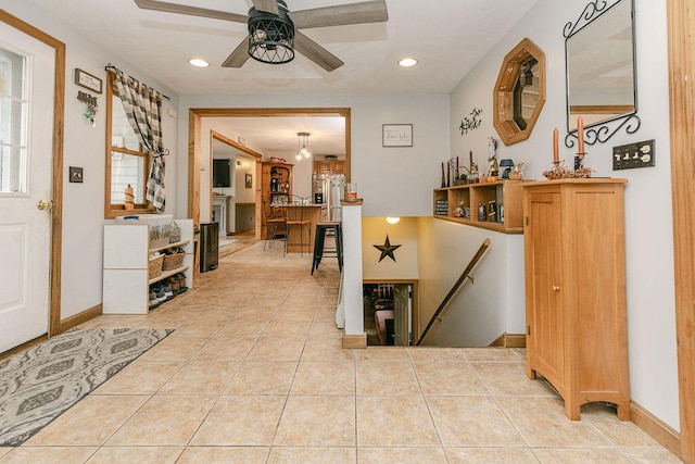 entryway featuring light tile patterned flooring and ceiling fan