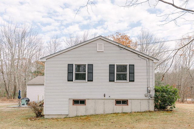 view of property exterior featuring a lawn