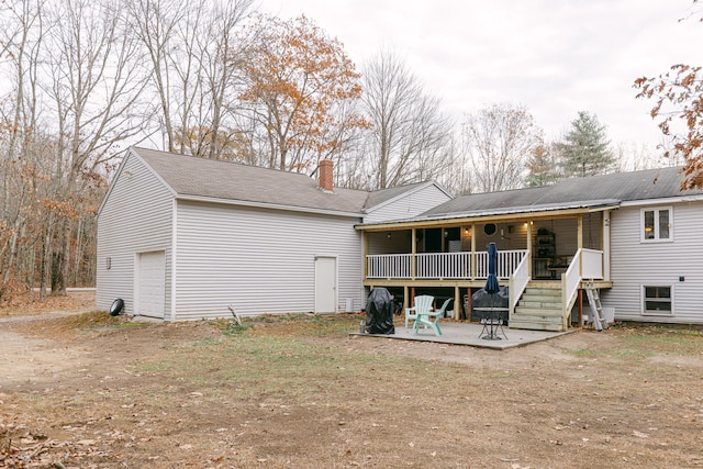 back of property featuring a garage and a porch