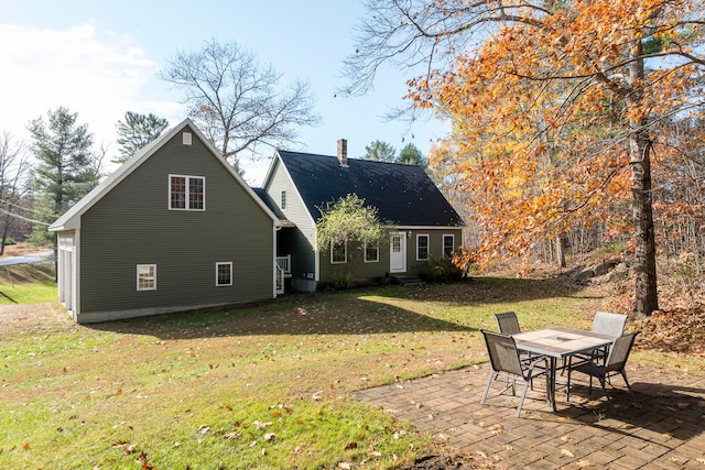 back of property featuring a lawn and a patio area