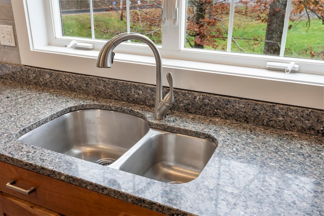 details with sink and dark stone countertops