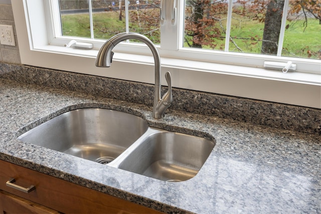 610 W Neck Rd, Nobleboro, ME 04555 - kitchen view of dark stone counters and brown cabinetry