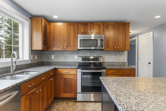 610 W Neck Rd, Nobleboro, ME 04555 - kitchen featuring stainless steel appliances, light stone countertops, tasteful backsplash, glass insert cabinets, and recessed lighting