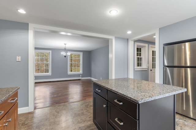 610 W Neck Rd, Nobleboro, ME 04555 - kitchen featuring freestanding refrigerator, a chandelier, a kitchen island, baseboard heating, and recessed lighting