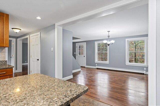 610 W Neck Rd, Nobleboro, ME 04555 - kitchen featuring a baseboard radiator, brown cabinets, light stone counters, dark wood-type flooring, and recessed lighting