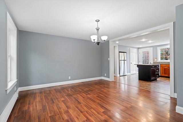 interior space with dark hardwood / wood-style flooring and a chandelier