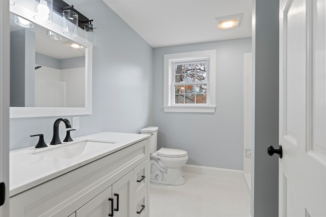 bathroom with vanity, toilet, and a shower