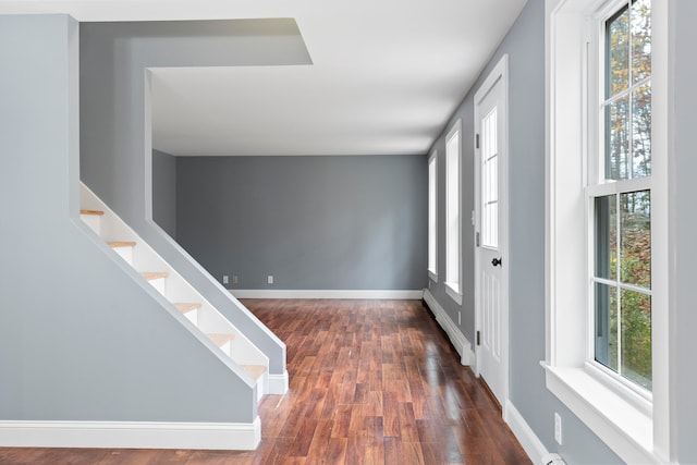 entryway featuring dark wood-type flooring and a baseboard radiator