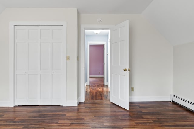 610 W Neck Rd, Nobleboro, ME 04555 - unfurnished bedroom with baseboard heating, dark wood finished floors, vaulted ceiling, and a closet
