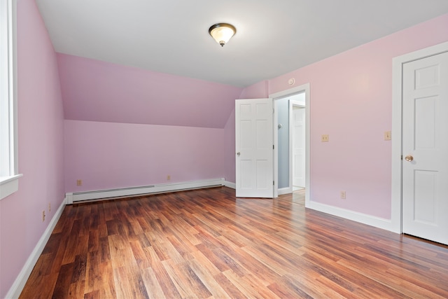 bonus room featuring hardwood / wood-style floors, a baseboard radiator, and lofted ceiling