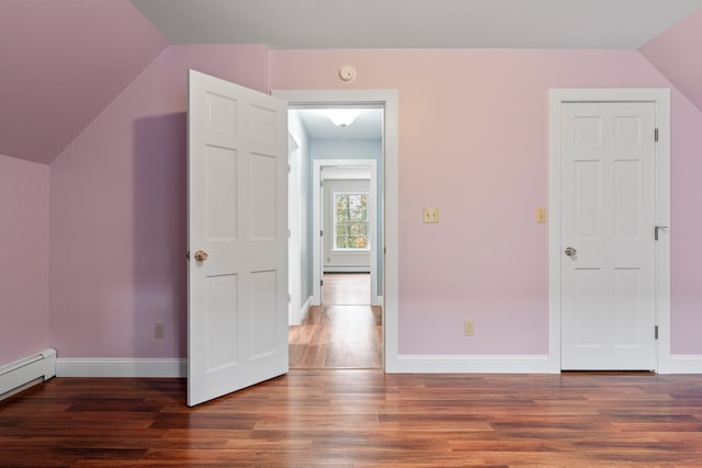 bonus room with a baseboard heating unit, dark hardwood / wood-style floors, and vaulted ceiling