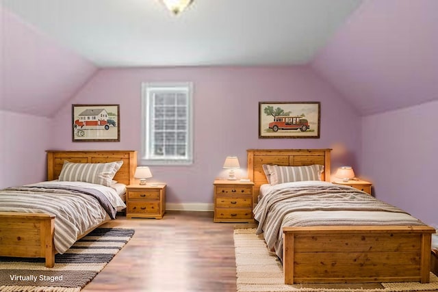 610 W Neck Rd, Nobleboro, ME 04555 - bedroom with lofted ceiling and wood finished floors