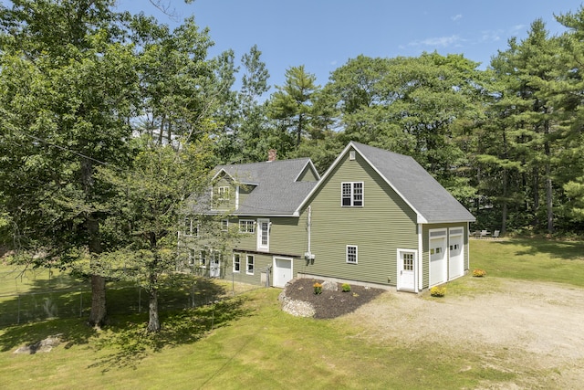610 W Neck Rd, Nobleboro, ME 04555 - view of home's exterior featuring a garage, a yard, a chimney, roof with shingles, and dirt driveway