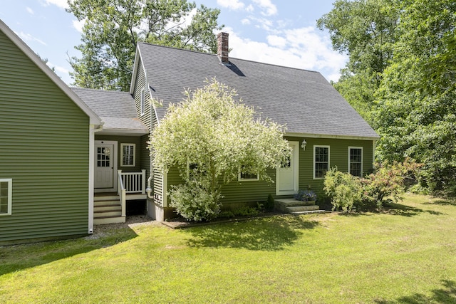 610 W Neck Rd, Nobleboro, ME 04555 - view of front of property with roof with shingles, a front lawn, and a chimney