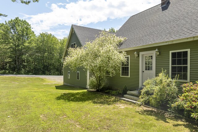 610 W Neck Rd, Nobleboro, ME 04555 - view of home's exterior with roof with shingles, a yard, and a chimney
