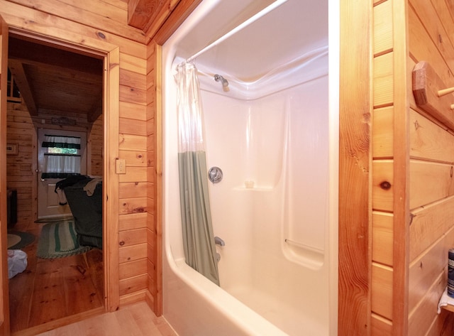 865 Barnard Rd, Williamsburg Twp, ME 04414 - bathroom featuring wood finished floors, shower / bath combo, and wooden walls