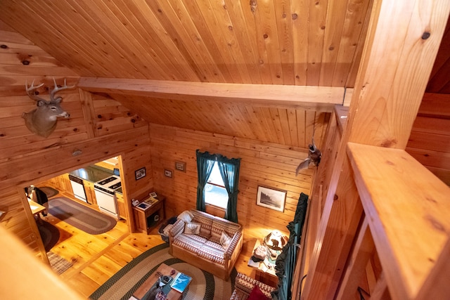 living room with wood ceiling, wood walls, vaulted ceiling, and hardwood / wood-style floors