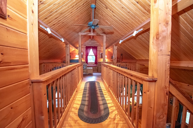 hallway featuring wood ceiling, wood walls, vaulted ceiling with beams, and hardwood / wood-style floors