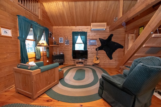 interior space with vaulted ceiling, hardwood / wood-style flooring, a wealth of natural light, and wooden walls