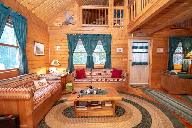 living room featuring vaulted ceiling, wood-type flooring, wooden ceiling, and wood walls