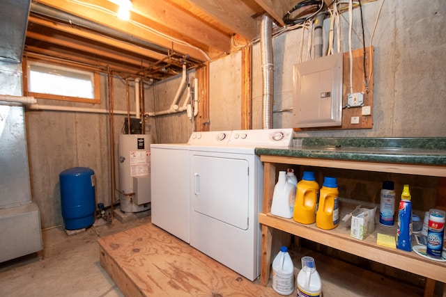 clothes washing area featuring water heater, electric panel, and washing machine and dryer