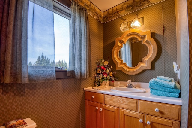 bathroom featuring vanity and toilet