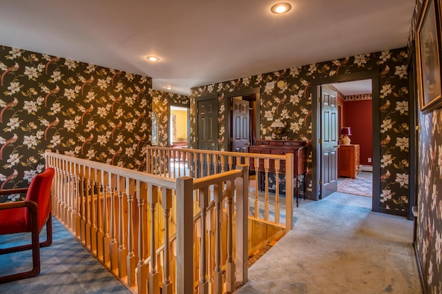 corridor with carpet flooring and a baseboard heating unit