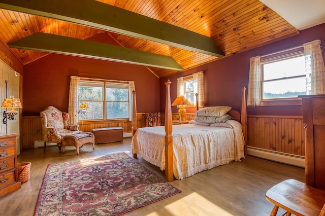 bedroom with multiple windows, a baseboard radiator, light hardwood / wood-style floors, and lofted ceiling with beams