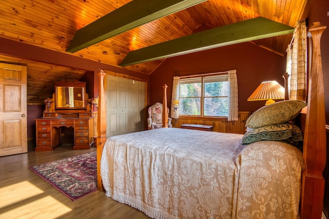 bedroom with lofted ceiling with beams, hardwood / wood-style flooring, and wooden ceiling