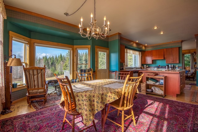 dining area featuring light hardwood / wood-style floors and a notable chandelier