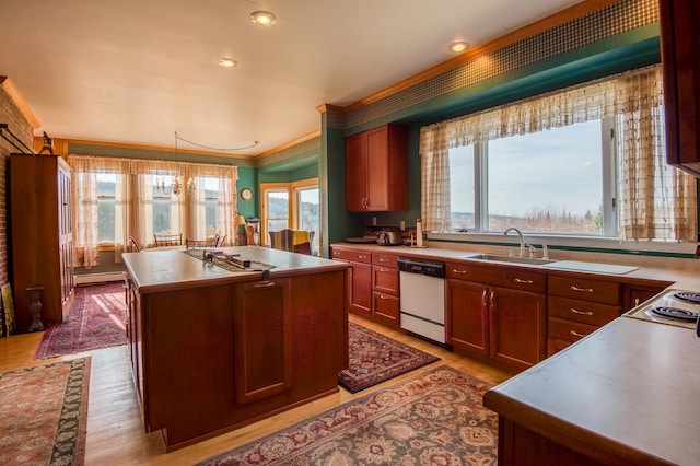 kitchen featuring light hardwood / wood-style floors, ornamental molding, white dishwasher, a kitchen island with sink, and pendant lighting