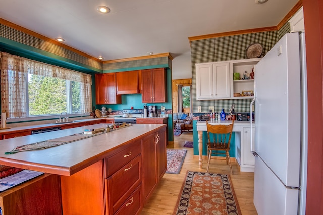 kitchen featuring tasteful backsplash, white fridge, sink, light hardwood / wood-style floors, and white cabinets