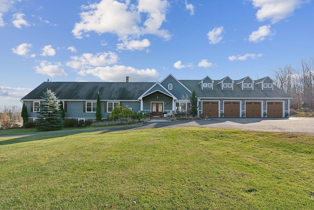 view of front of home featuring a front lawn and a garage