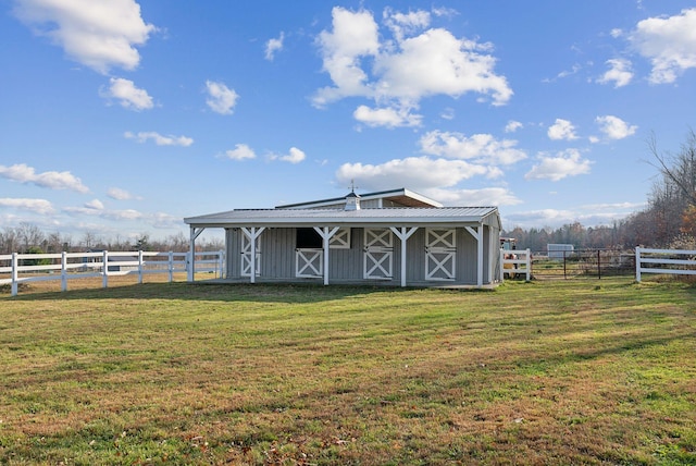 view of outdoor structure featuring a yard and a rural view