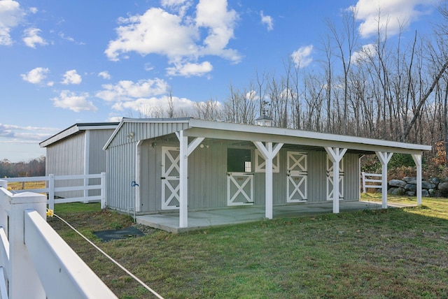 view of outbuilding with a yard