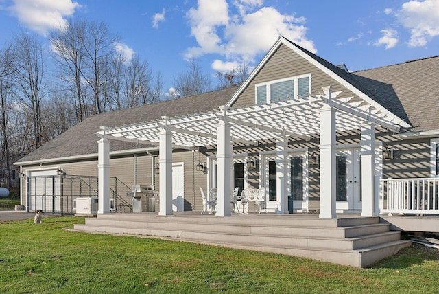 back of property with a wooden deck, a lawn, and a pergola