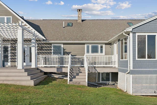 back of property featuring a pergola and a lawn