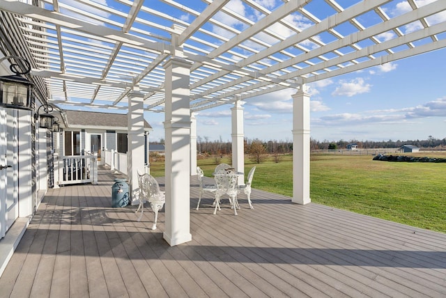 wooden terrace featuring a lawn and a pergola