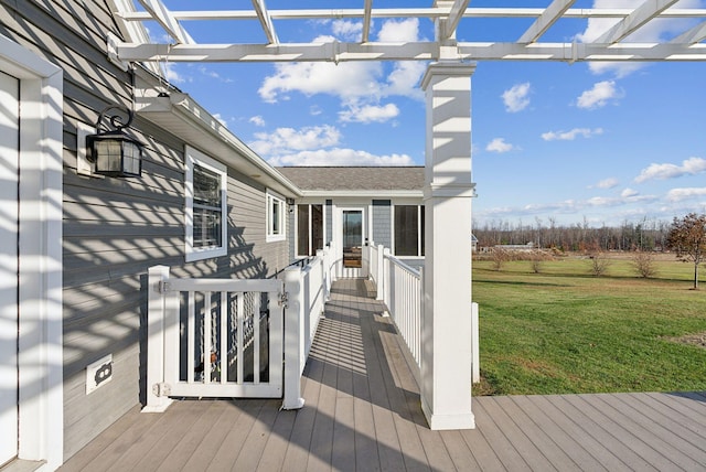 wooden terrace featuring a lawn and a pergola