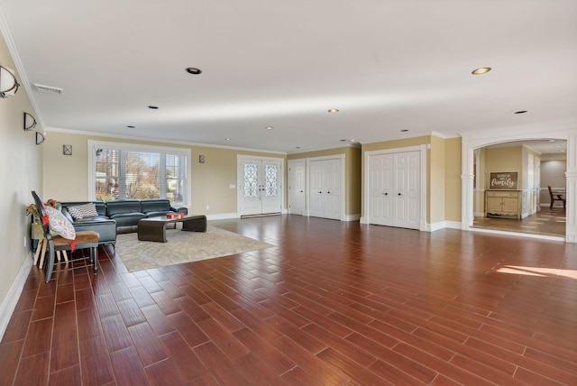 living room with crown molding and dark hardwood / wood-style flooring