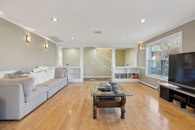 living room with light hardwood / wood-style flooring, ornamental molding, and baseboard heating